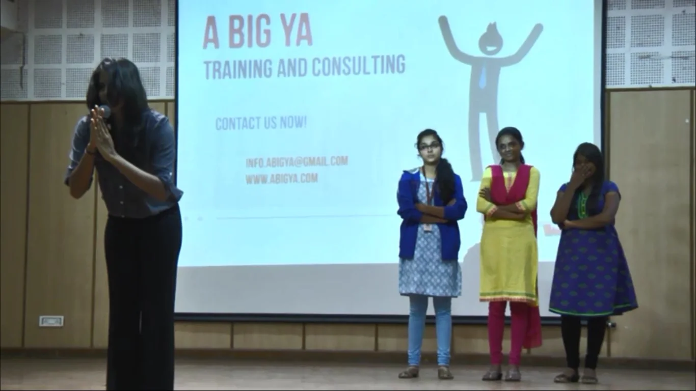 A student speaks into a microphone during an Abigya session